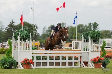 Ainsley Vince of Burlington, ON, and Magic Show, owned by Knightwood Stables, on their way to victory in the 0,000 Canadian Hunter Derby at the Ottawa International at Wesley Clover Parks on Sunday, June 21. (Photo: Ben Radvanyi Photography)