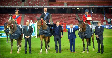 The winners of the team jumping competition, Zhiwen Zhao, Marco Kutscher and Zhenqiang Li, at the prize-giving ceremony.