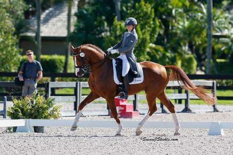 Stacy competing aboard Benidetto with husband Olof looking on. 