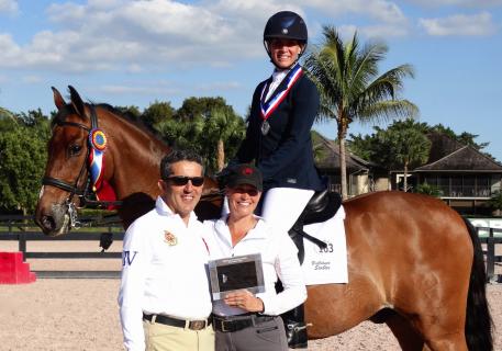 Charlene Moskowitz, with her trainer Denielle Gallagher-Legriffon (right), wins the Piaffe Performance Adult Amateur Achievement Award at the Adequan Global Dressage Festival, presented by Dr. Cesar Parra (left) 