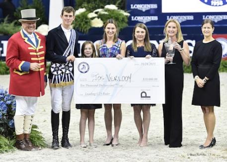 Jos Verlooy is presented with the Sleepy P Ranch Leading Under 25 Rider award and Juliet Weber Reid Trophy by ringmaster John Franzreb, Zola Thompson, WIHS Operations & Events Director Caitlin Lane, WIHS President Victoria Lowell, WIHS Director Emeritus Juliet Reid, and WIHS Executive Director Bridget Love Meehan.