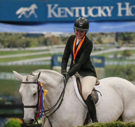 Hunter Holloway congratulates C'est La Vie after winning the 2016 ASPCA Maclay Horsemanship Championships