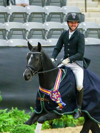 Region 9’s John Mason and U.S.-bred Savannah SWF celebrate their victory in the Training Level Open Championship. 