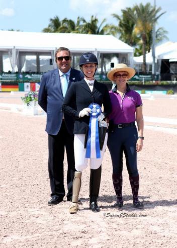 Katie Jackson, winner of the Para Team Test Grade V, with judge Carlos Lucas Lopes (POR) and Rowan O'Riley of Mane Stream.