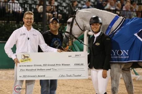 Luis Salvaras accepts the Absorbine FEI Groom's Award with rider Kristen Vanderveen and Lance Bennett of TIEC.