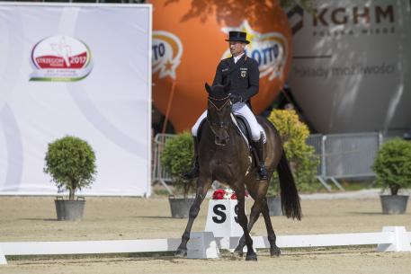 Defending champion Michael Jung (GER) rides into third place individually on fischerRocana and puts the German team into a commanding lead after the dressage at the FEI European Eventing Championships in Strzegom (POL).