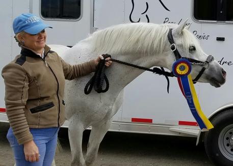 Champion Pony winner Melissa Mulchahey and her stallion Petit Marc Aurel celebrate at an NDPC Partner Show in California. 