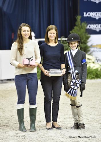 Farah Rizvi accepts the award for Best Child Rider on a Pony with WIHS Youth Ambassador Miriam Dupree and WIHS Executive Director Bridget Love Meehan