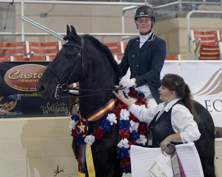 Susan Bouwman-Wind, riding Annette Coester’s Jesse 435, wins the Custom Saddlery Most Valuable Rider (MVR) Award at the 2015 International Friesian Show Horse Association (IFSHA) World and Grand National Championship horse show