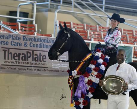 Bruce Griffin, TheraPlate Brand Ambassador, presents Tymo Fan de Stuken and rider Kassandra Sapia with the TheraPlate Peak Performance Award at the 2015 International Friesian Show Horse Association (IFSHA) World and Grand National Championship Horse Show 