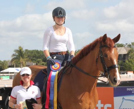 Barbara “Bebe” Davis receives the Premier Equestrian Sportsmanship Award with her trainer Katie Riley of Piaffe Performance at the 2015 Adequan Global Dressage Festival.