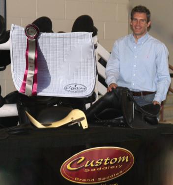Custom Saddlery’s Cary Wallace prepares to present the Custom Saddlery Most Valuable Rider Award at the 2015 Adequan Global Dressage Festival 