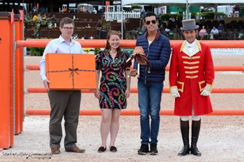 Emanuel Andrade, 18, of Venezuela is presented with the Hermes Talented Young Rider Award.  From left to right:  James Sardelli, Senior Equestrian Account Manager of Hermes; Monique Connelly, Equestrian Specialist for Madison Ave. Hermes Boutique; Emanuel Andrade; and ringmaster Gustavo Murcia. Photo by Starting Gate Communications