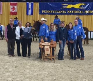 Feaser and Lil' Red accept their first place prize of a saddle donated by Cowboy Classics Saddlery. (c) A Home for Every Horse