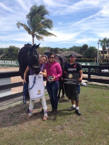 Lakota HD scored 73.16% in Intermediaire II winning high point of US bred horses at White Fences Summer fun. Pictured (L-R): Assistant Trainer Hyui Jin Vervoort and groom Wifredo. Degele has trained Lakota from Training Level all the way to Grand Prix. (Photo: Katie Hoog)