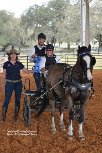 Co-Organizer Jennifer Matheson presents the winning ribbon to Cefnoakpark Bouncer and Wayne Humphreys with US Combined Driving Team veteran Joe Yoder as navigator Photo: © Kathleen O'Grady