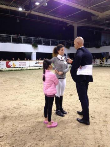 Laura Mathy speaking to the crowd about the JustWorld cause with André Jacques Legoupil. Photo: Courtesy of Client