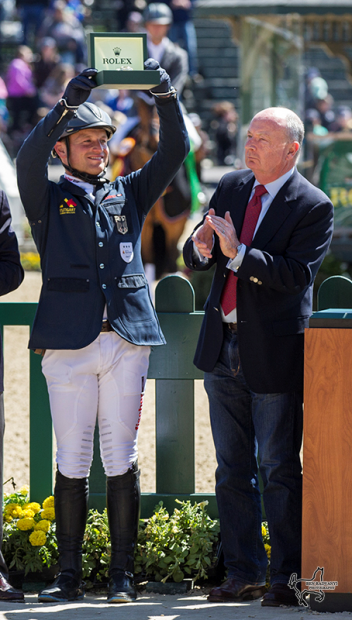 Winner Michael Jung hoists the winner's Rolex watch as Stewart Vicht, chief executive officer and president of Rolex Watch USA, applauds him. (Photo: Ben Radvanyi)   