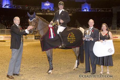 Neil Badcock, 44, of King City, Ont., won the Jump Canada Talent Squad Final on Saturday, November 8, at Toronto's Royal Horse Show riding Corrido. Peter Cullen, member of the Board of Directors of the Royal Agricultural Winter Fair Association, presented Badcock with the Championship trophy and ribbon. Photo Credit - Cealy Tetley