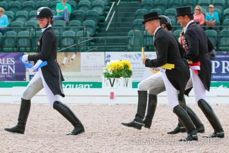 Adrienne Lyle leads the victory gallop after the prize-giving ceremony as Lars Petersen, Karen Pavicic and Christop Koschel take up the rear. 