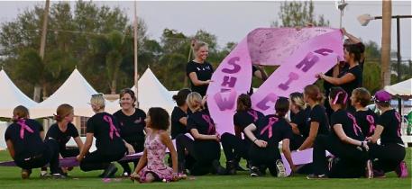 Team Showchic’s 20 dressage-connected volunteers shaped a giant pink ribbon on centerline that was signed by spectators honoring the names of cancer survivors and loved ones in remembrance.