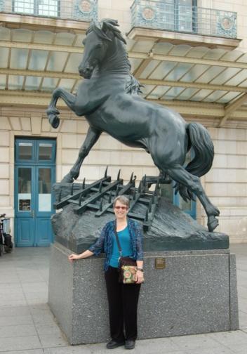 Father Mack’s beloved wife and part-time equestrian photographer (Ruth Shaw McCormick) takes note of the question posed by this horse friend in the forecourt of the Musée Orsay Paris)