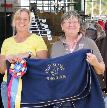 Beth Haist (right), CEO of The Horse of Course, presents the Horse of Course High Score Award to Sara Schmitt (left) at the 2015 AGDF