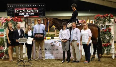 Sydney Hutchins and Gaudi, pictured with (l-r) Melissa Brandes of Blenheim EquiSports, George Morris, Ecole Lathrop, Archie Cox, and Elvenstar trainers Katie Gardner, Jim Hagman and Kay Altheuser.  Photo courtesy of CapturedMomentPhoto.com