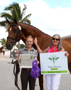 Rider Mary Rollins (left) and owner Teresa Simmons (right) stand with their TheraPlate Award winner Royal Prinz at the Adequan Global Dressage Festival
