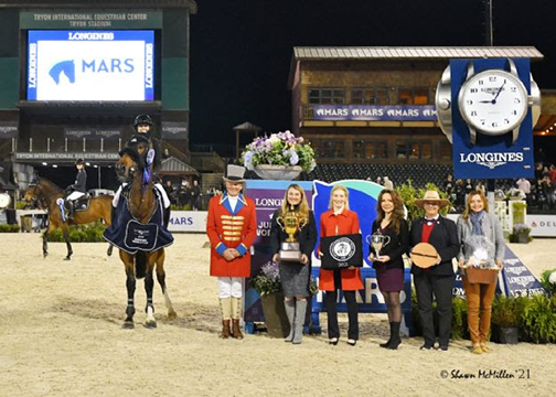 Tiffany Foster and Figor in their presentation with ringmaster Steve Rector, WIHS President Vicki Lowell, WIHS Chairman Anne Poulson, WIHS Vice President Evelyn Liu Treacy, FEI Foreign Judge Collene Hoffman, and Dr. Bridgett McIntosh, Director MARS Equestrian™. ﻿Photo by Shawn McMillen Photography